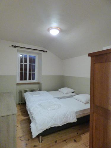 a bedroom with two beds and a window at Village de gîtes de Sainte-Lucie in Sainte-Lucie
