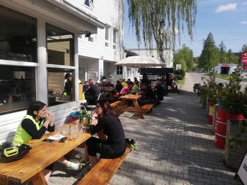 a group of people sitting at tables outside a restaurant at Apartmán Doupě in Humpolec