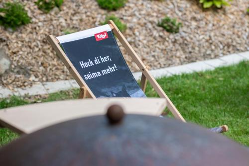 a sign sitting on a chair next to a table at Ferienhaus Viktoria in Abfaltersbach