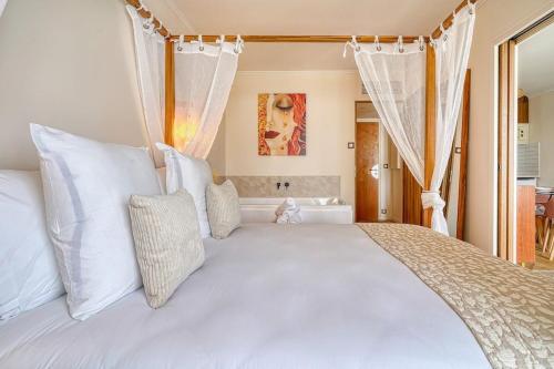 a bedroom with a large white bed with white pillows at Inn Place to be Paris La Defense in Courbevoie