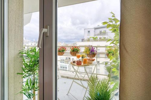 a view from a window of a balcony with plants at Inn Place to be Paris La Defense in Courbevoie