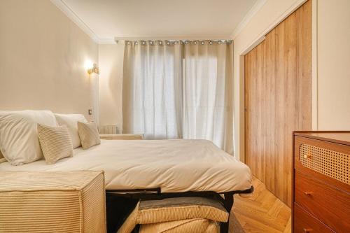 a bedroom with a large bed and a window at Inn Place to be Paris La Defense in Courbevoie