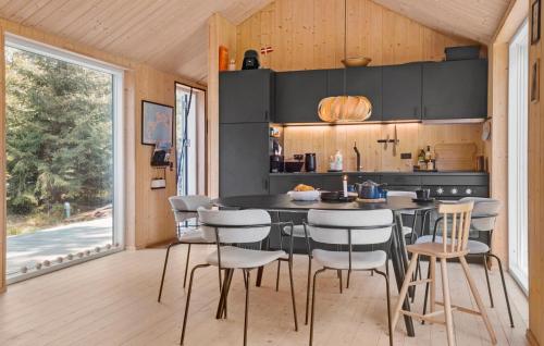 a kitchen with a table and chairs in a room at 3 Bedroom Amazing Home In Stege in Stege