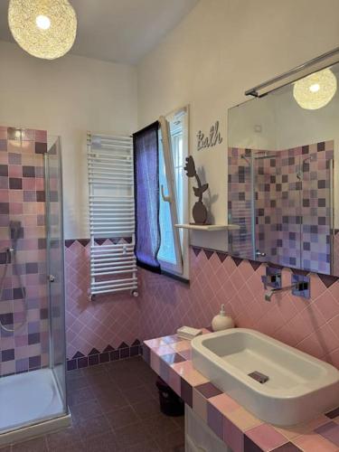 a bathroom with a tub and a sink and a shower at Casa Anna Asciano in Asciano Pisano