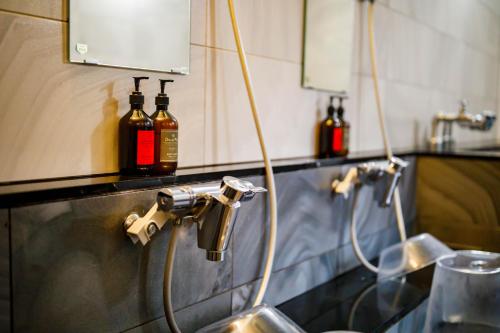 a kitchen with a sink and some bottles on a counter at Hotel Sunplaza 2 Annex in Osaka