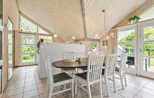 a dining room with a table and chairs at Beautiful Home In Oksbøl With Sauna in Oksbøl