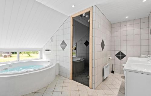 a large bathroom with a tub and a sink at Beautiful Home In Oksbøl With Sauna in Oksbøl