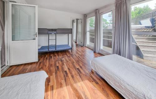 a bedroom with two beds and a wooden floor at 4 Bedroom Cozy Home In Angered in Angered