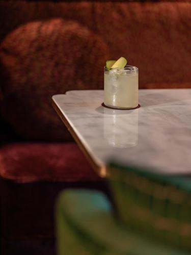 a candle on a table with a book at Boudoir des Muses in Paris