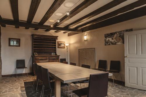 a dining room with a wooden table and chairs at Village de gîtes de Sainte-Lucie in Sainte-Lucie