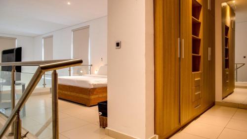 a room with a bedroom with a bed and a door at Lakowe Lakes Hotel, Golf and Country Estate by NEWMARK in Lagos