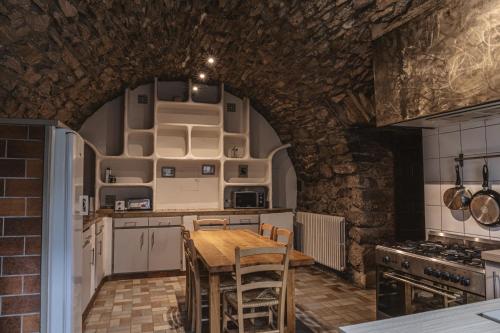 a kitchen with a table and chairs in a room at Village de gîtes de Sainte-Lucie in Sainte-Lucie