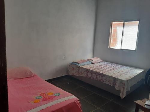 Ένα ή περισσότερα κρεβάτια σε δωμάτιο στο Casa aconchego