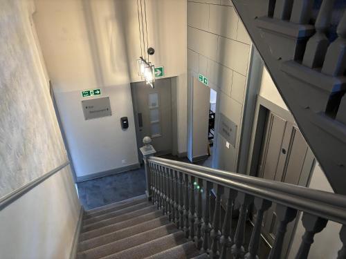 a staircase in a building withexit signs on the wall at Richmond Park Hotel in Boʼness