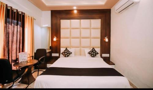 a hotel room with a bed and a table and chairs at Mangal Residency in Bedla