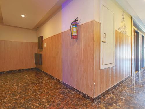 a hallway with wooden walls and a stained glass window at Mangal Residency in Bedla