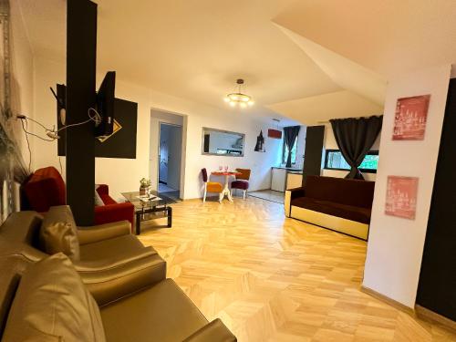 a living room with a couch and a table at Hamilton Apartment in Craiova