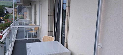 a balcony with a table and chairs on a building at Hotel Ehnen in Ehnen
