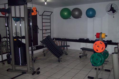 a room with a gym with exercise equipment and balls at Hospedaria Ondas do Rosa in Praia do Rosa