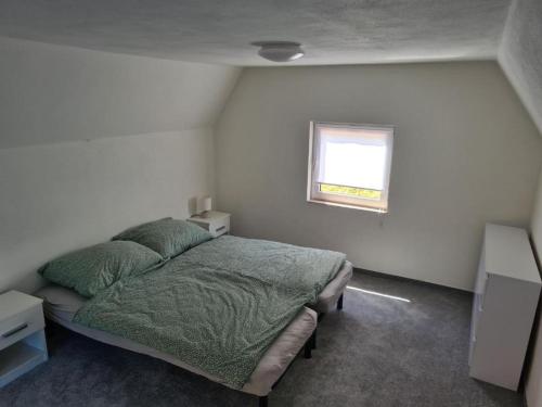 a bedroom with a bed and a window at Chatka Terezka in Žilina