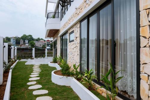 a balcony of a building with grass and plants at Xenia House Cao Bang City in Cao Bằng