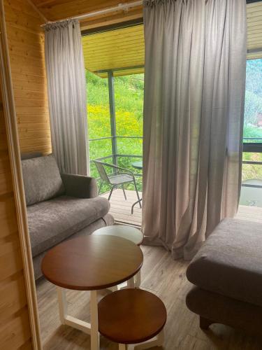 a living room with a couch and a table at MetiTsa in Jut'a