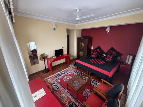 an aerial view of a living room with a bed at New Serkong House in Dharamshala