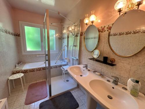 a bathroom with a sink and a shower and a tub at 763 - Maison bretonne en bord de mer in Erquy