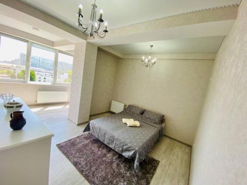 a bedroom with a bed and a chandelier at Dream HOME 2 Rooms Apartment in Chişinău
