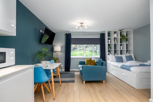 a living room with a bed and a dining room at Alison Court - Urban Apartments in Bristol