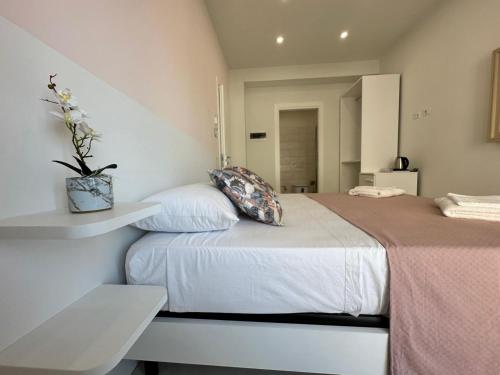a bedroom with a bed with a plant on it at Pasitea Tropea in Tropea