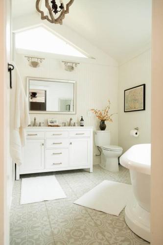 a white bathroom with a sink and a toilet at Historic Garden Suite Walk to Bay and Downtown - Suite Two in Fairhope