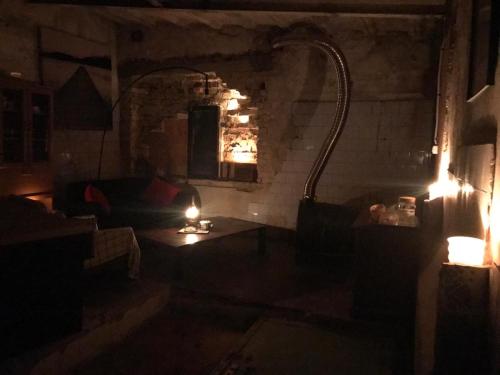 a dark room with a couch and a table with lights at Rooftop terrace Green Sky in Vilnius