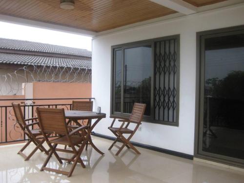 a patio with a table and chairs on a balcony at Ghouse room A Ideal For Friends family And Corporate in Lateman