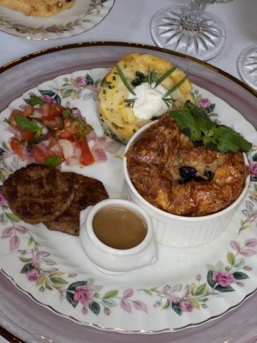 a plate with a bowl of food and a cup of coffee at Central Park Bed & Breakfast in Louisville