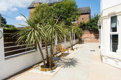 a palm tree on a sidewalk next to a building at Modern Apartment Spacious Double Bed Off Road Parking Suite 8 in Nottingham
