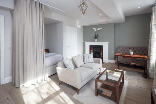 a living room with a couch and a bed at Beech House - Urban Apartments in Bristol