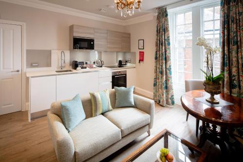 a living room with a couch and a table at Beech House - Urban Apartments in Bristol