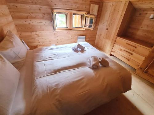 a dog laying on a bed in a cabin at Rustic Alpine 1BR Getaway- Unwind and Reconnect in Reckingen - Gluringen