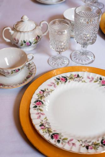 a table with plates and glasses and a teapot at Central Park Bed & Breakfast in Louisville