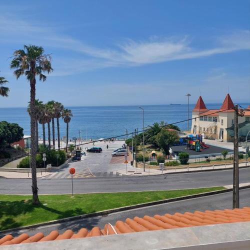 a view of a street with a beach and the ocean at RENT4REST Estoril Seafront Apartments in Estoril
