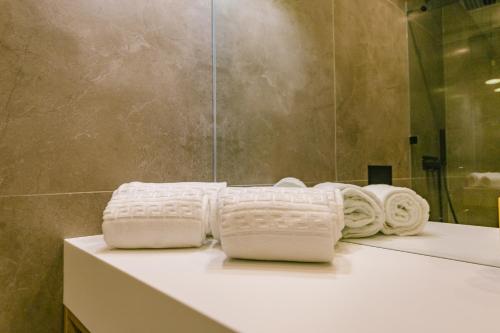 a bathroom with two towels sitting on a counter at RENT4REST Estoril Seafront Apartments in Estoril