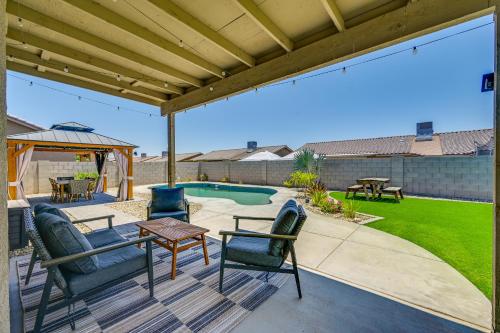 a patio with chairs and a table and a pool at Pet-Friendly Yuma Home with Private Yard and Pool! in Fortuna