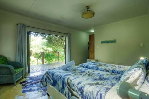 Una cama o camas en una habitación de Baleia Azul 26