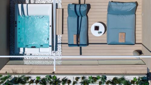 an aerial view of a house with a swimming pool at Flisvos Royal Hotel & Suites in Tolo