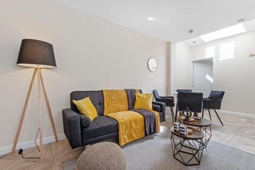 a living room with a blue couch and chairs at Modern Apartment Free Off Road Parking 2x Double Rooms Suite 11 in Nottingham