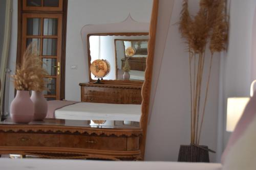 a bedroom with a mirror and a wooden dresser at Vista Mare in Mattinata