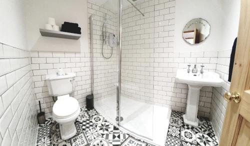 a bathroom with a toilet and a sink and a shower at Seagulls Nest Holiday Cottage in Blackpool