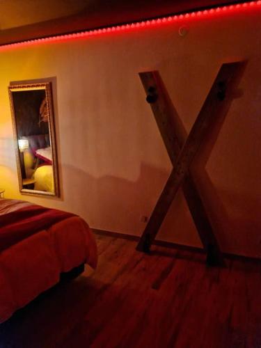 a bedroom with a mirror on the wall and a bed at Escapade Romantique à Saint Omer-Espace Totalement Privatisé Avec Terrasse in Saint-Omer