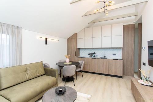 a living room with a couch and a table at LEX apartments in Palanga